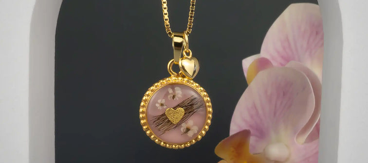 Kettenanhänger verziert in der Farbe Gold mit Tierhaaren und Blüten.