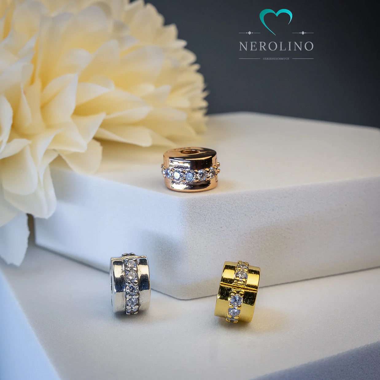 Stopperperle mit einreihigen Zirkoniabesatz in Silber, Gold und Roségold. 